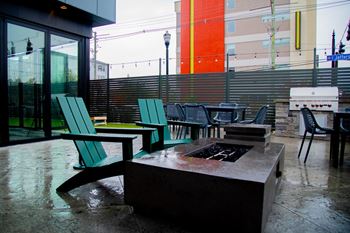 a patio with chairs and a fire pit at 310 at Nulu Apartments-Student, Kentucky, 40202